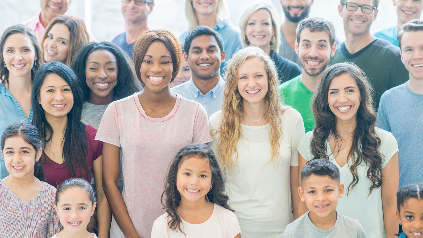group of people standing and smiling